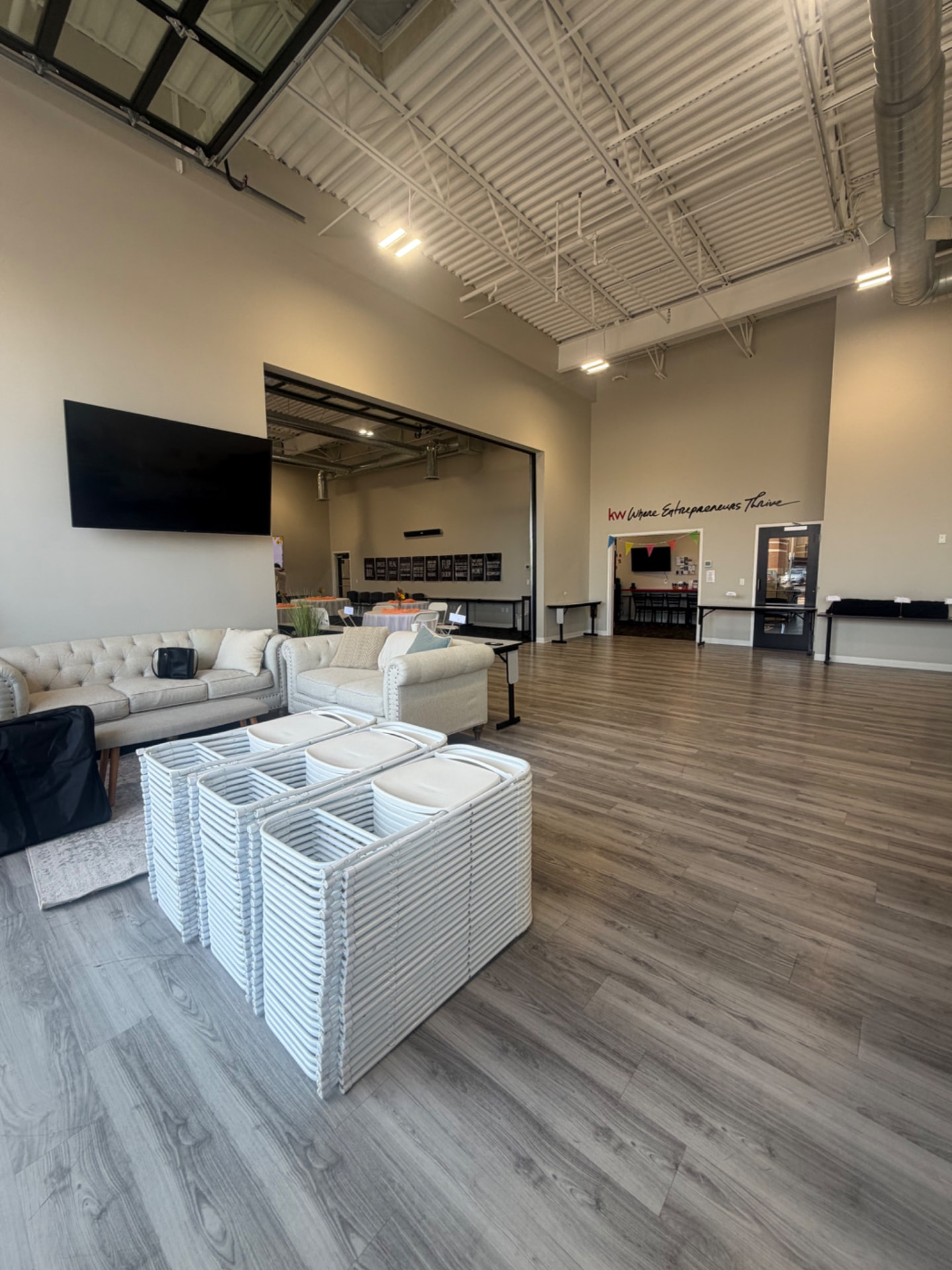 White folding chairs delivered to an open office event space